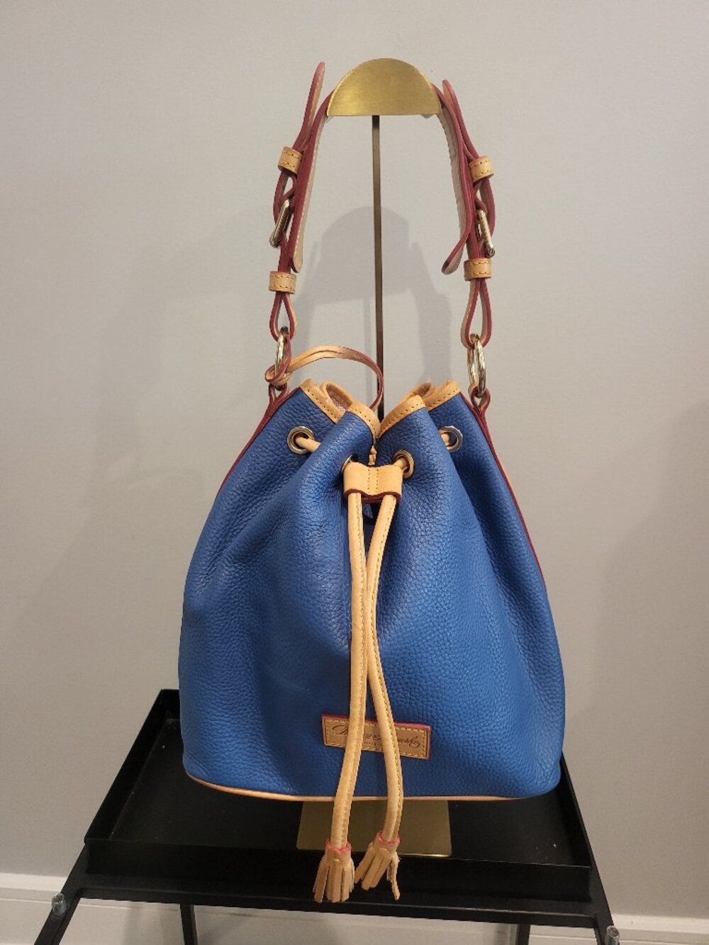Dooney & Bourke Pebble Grain small drawstring bag in the color jean